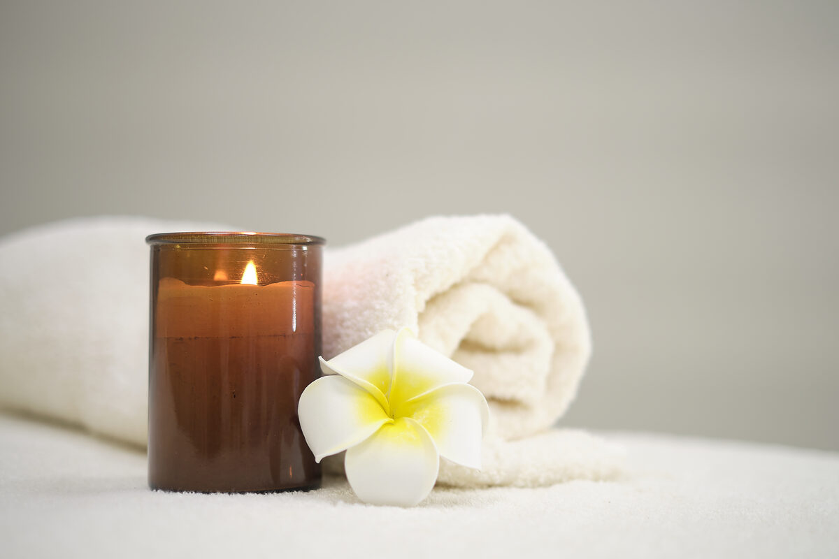 Candle and flower in a calm wellness setting
